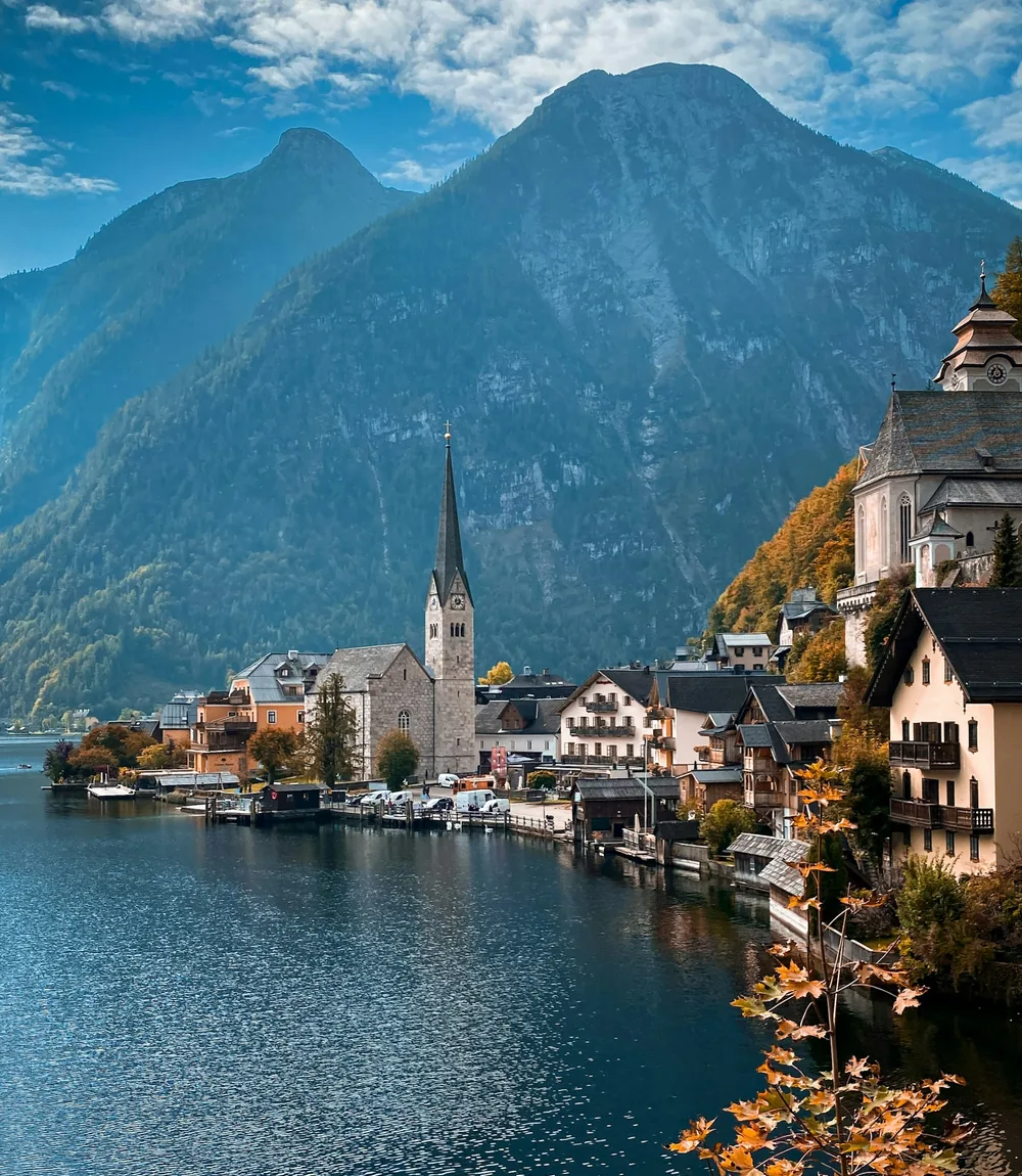 Pastel houses and a church spire on the shore of Lake Hallstatt